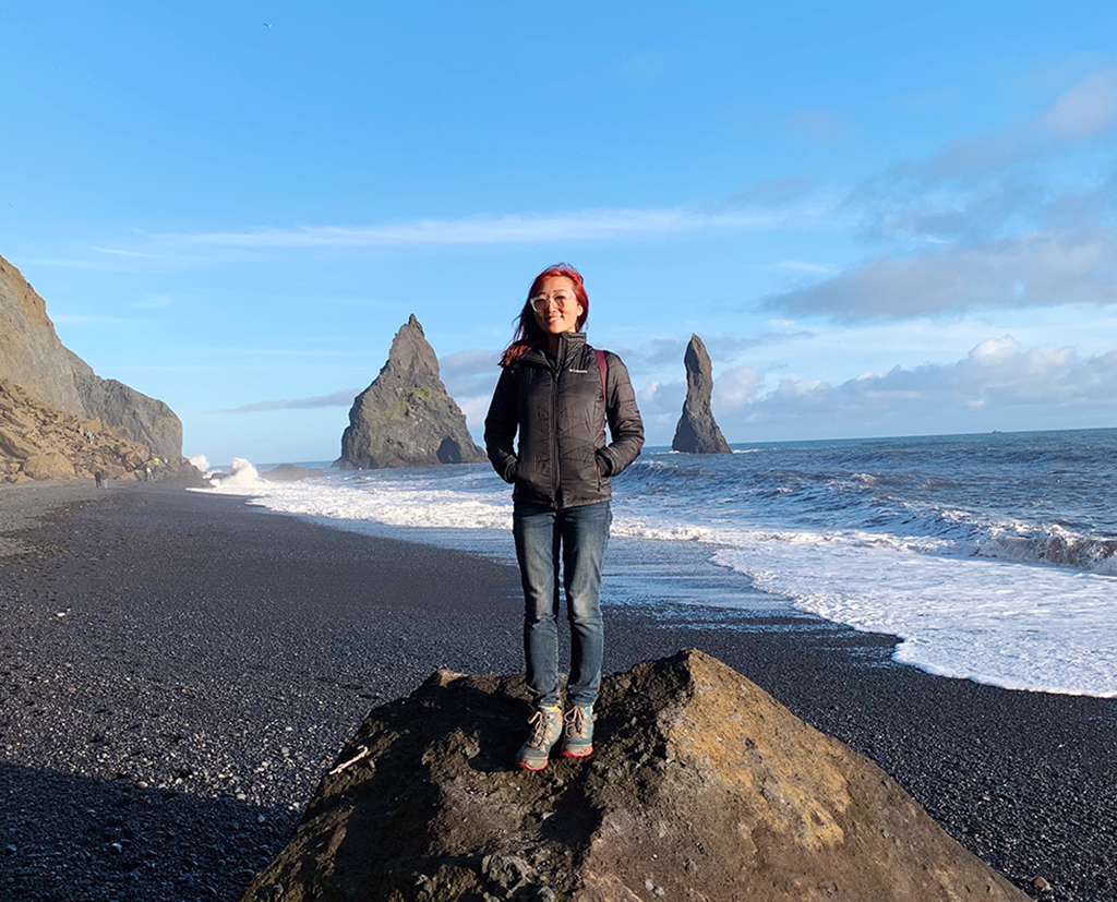Steph standing on a rock at Reynisfjara Beach