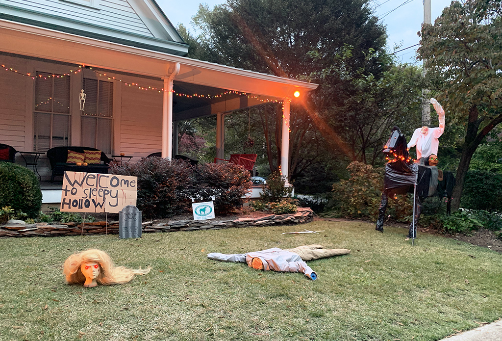 yard with a sign saying 'Welcome to Sleepy Hollow' with a headless horseman and victim