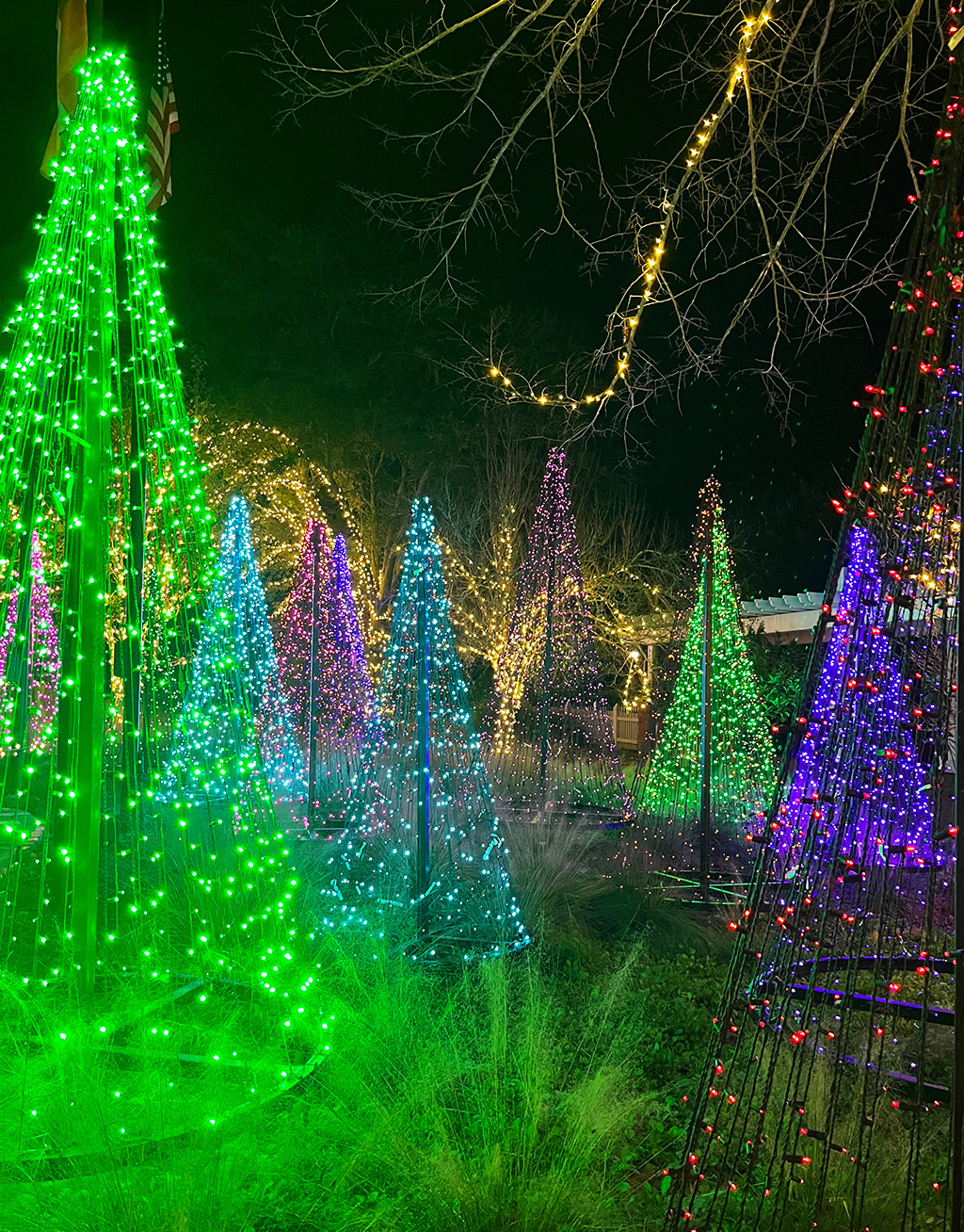 christmas cone trees made out of colorful lights