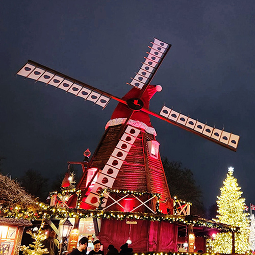 a red windmill with a santa hat