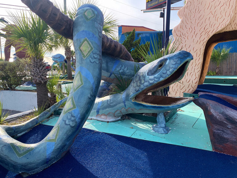 sculpture of a blue snake on a mini golf course