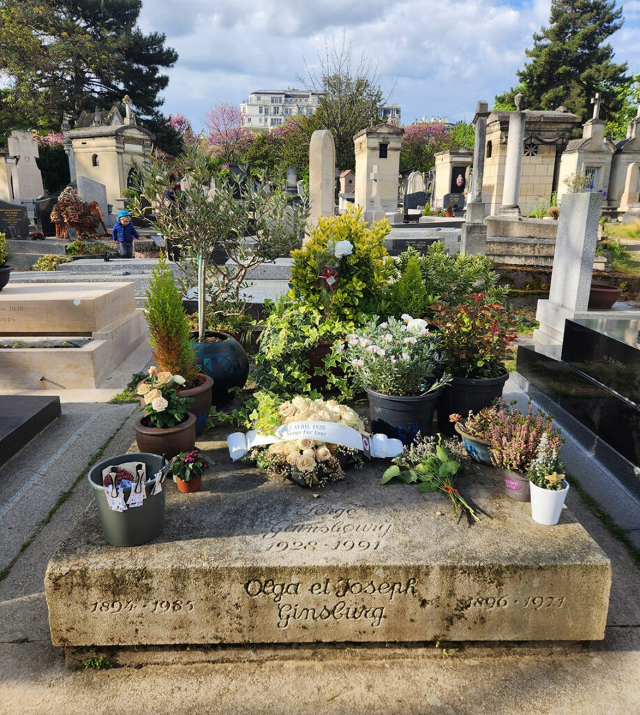 a tomb covered in flowers and metro tickets