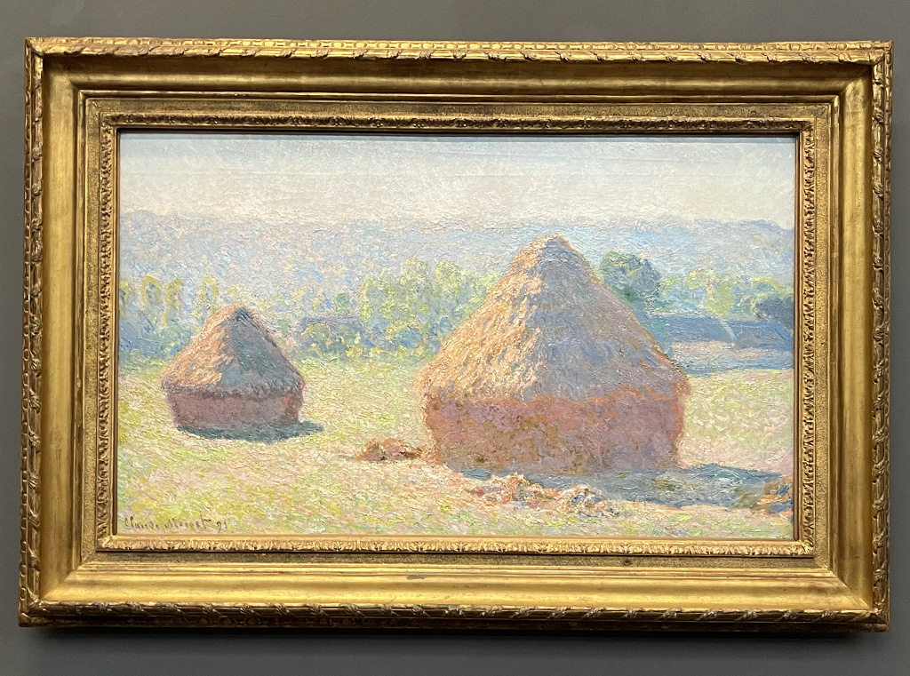 painting of haystacks in a field