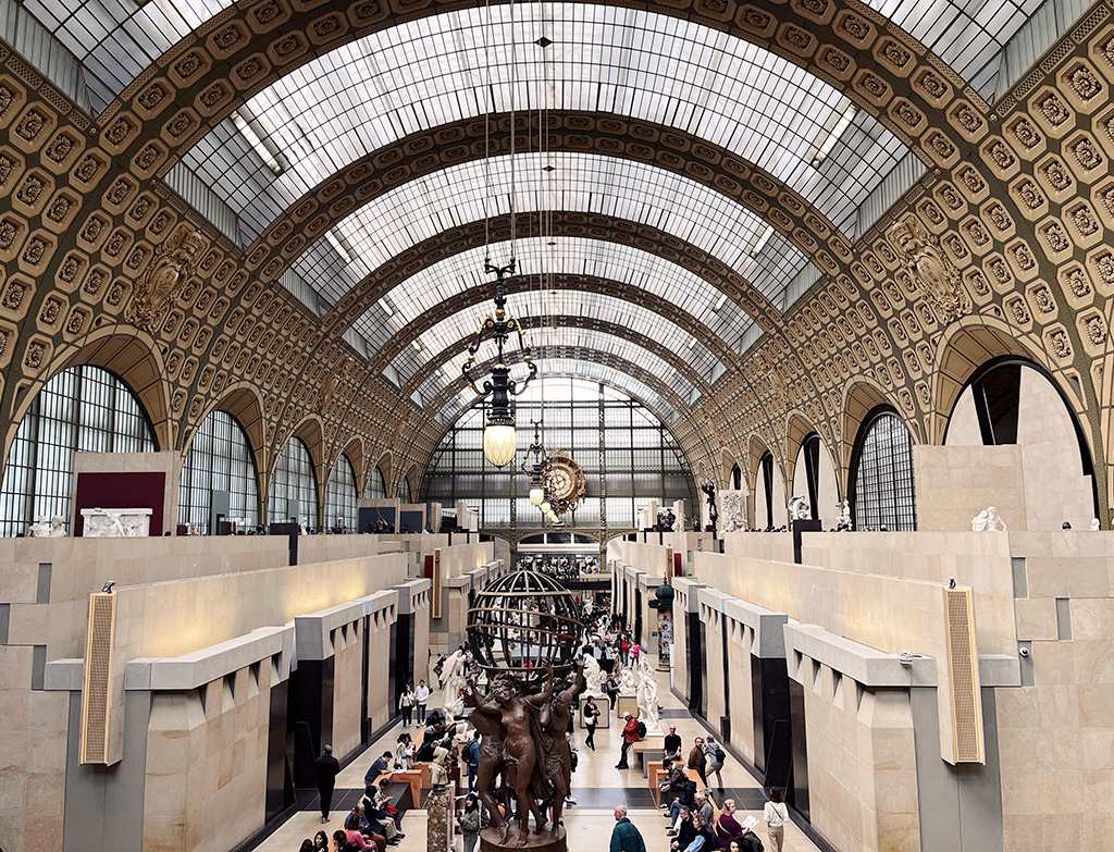 a converted train station art gallery with sculptures on the floor