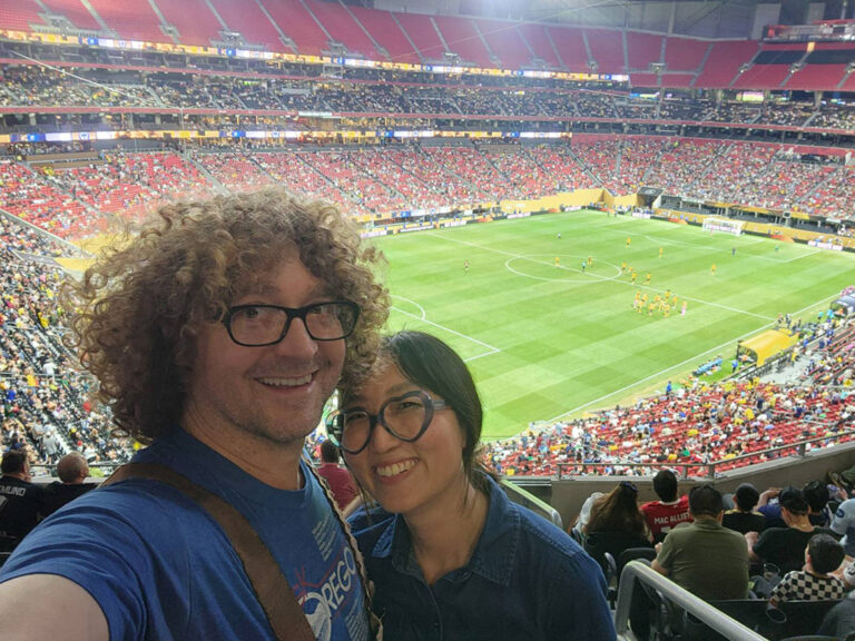 couple taking selfie in soccer stadium